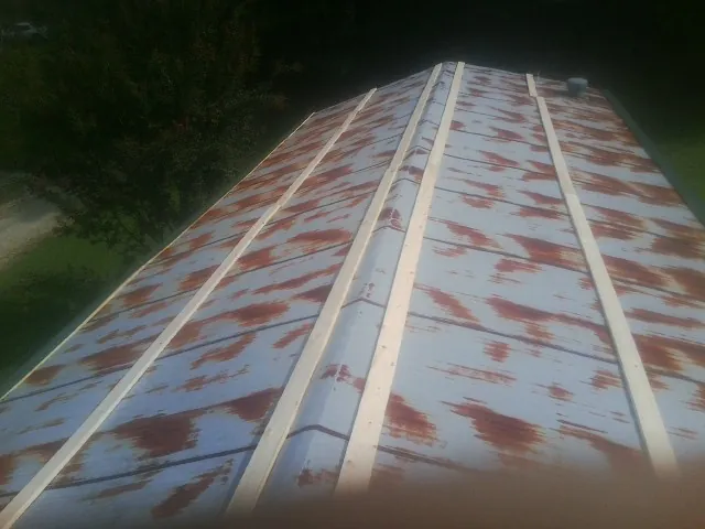 Rusted metal roof panels with new wood purlins before replacement — Storm Damage Roof Repair in Cabot by Roofing Brothers
