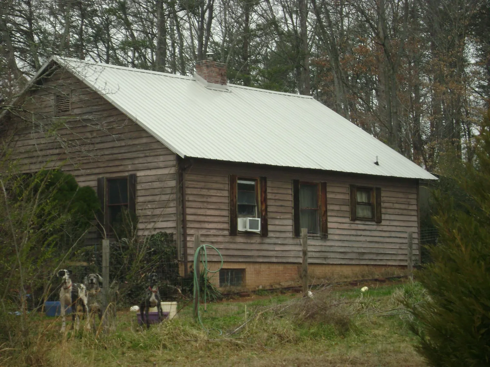 White metal roof on an old wood sided farmhouse, from a Metal Roof Installation job in Cabot
